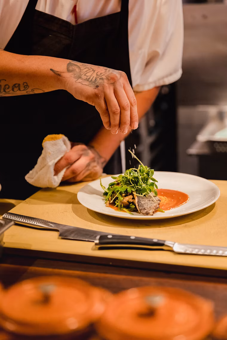 Restaurant chef plating a dish